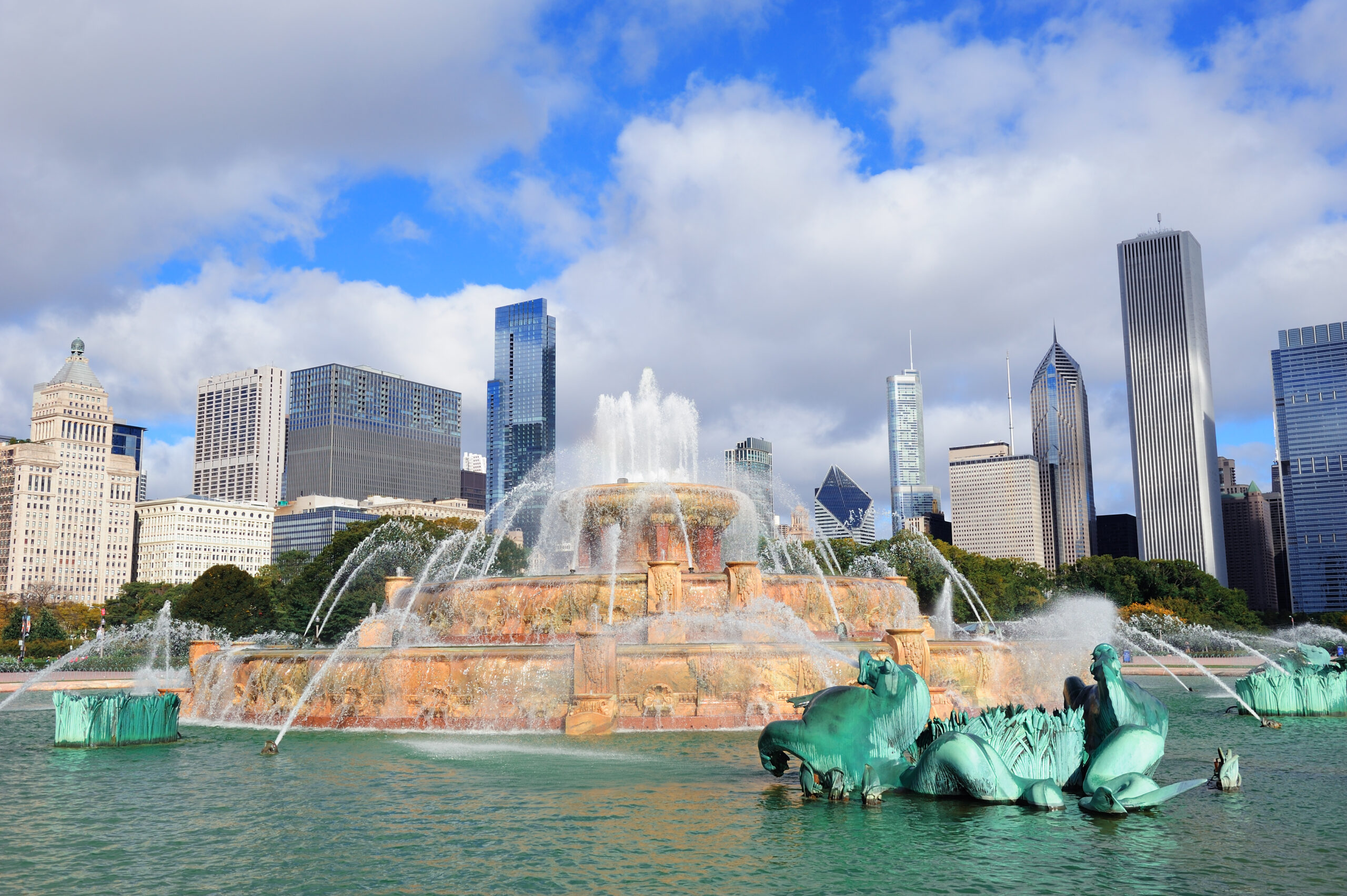 Chicago skyline panorama with skyscrapers and Buckingham fountain in Grant Park in the morning with cloud and blue sky.